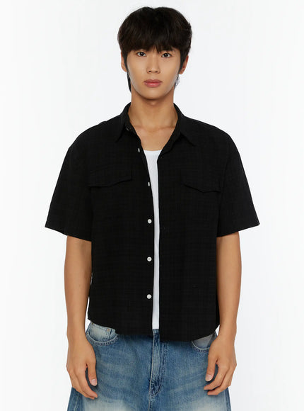 Men's Plaid Button-Up Shirt IL513 Black close-up front shot on model showing dual chest pockets, white button placket, open collar, and textured fabric