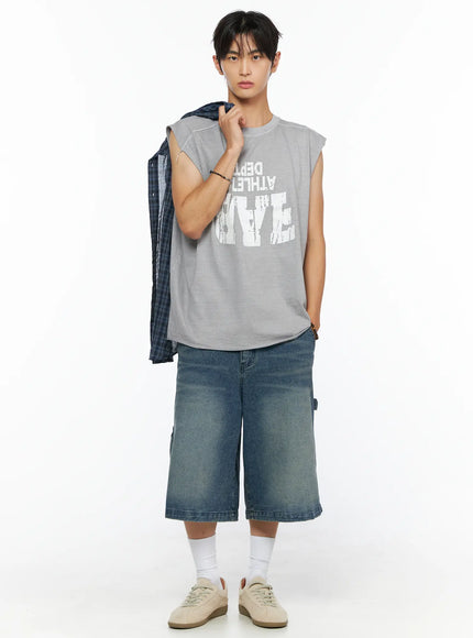 Men's Plaid Button-Up Shirt IL520 Dark blue styling shot, model holding shirt over shoulder wearing gray sleeveless graphic tee and denim shorts, front view
