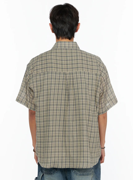 Men's Plaid Button-Up Shirt IL520 khaki green back shot on male model, plaid short-sleeve shirt showing center back seam and boxy silhouette over denim