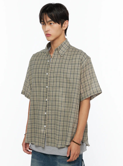 Men's Plaid Button-Up Shirt IL520 khaki green side close-up on male model, boxy short-sleeve plaid shirt layered over gray tee with white button detail