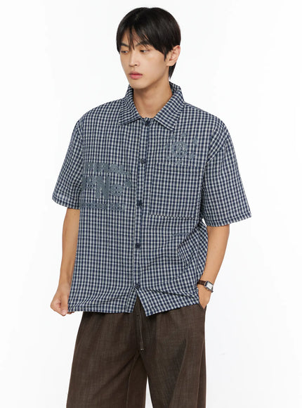 Men's Plaid Graphic Button-Up Shirt IL528 navy close-up front crop shot on male model showing seersucker plaid texture and tonal graphic lettering