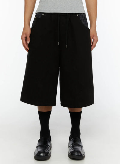 LEWKIN Men's Plaid Pocket Bermuda Shorts (Black) IL507 front view on male model wearing gray tee and black loafers, wide-leg silhouette with drawstring waist