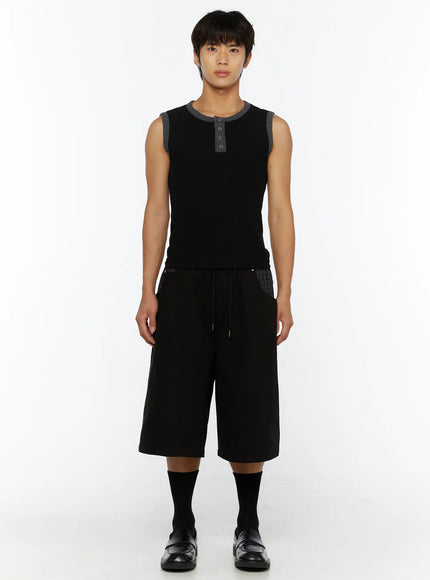 Men's Plaid Pocket Bermuda Shorts (Black) IL507 full front view on male model in black sleeveless henley top and black loafers, knee-length wide-leg fit