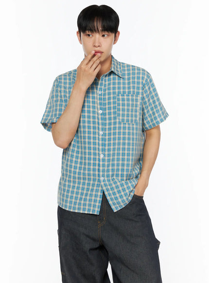 Men's Plaid Short Sleeve Shirt IL510 Blue cropped front shot on model with hand near mouth thoughtful pose buttoned placket and chest pocket detail
