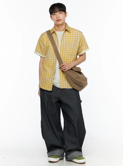 LEWKIN Men's Plaid Short Sleeve Shirt IL510 Yellow full-body front shot on model standing with brown crossbody bag layered over white graphic tee and dark wide-leg jeans