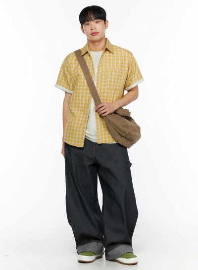 LEWKIN Men's Plaid Short Sleeve Shirt IL510 Yellow full-body front shot on model standing with brown crossbody bag layered over white graphic tee and dark wide-leg jeans