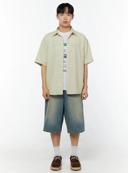 Men's Plaid Short Sleeve Shirt IU529 Light yellow front shot on male model standing straight arms at sides layered over graphic tee with wide-leg denim shorts