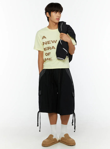 LEWKIN Men's Pocket Cargo Shorts IL515 Black full-body front shot on male model styled with yellow graphic tee and tan loafers