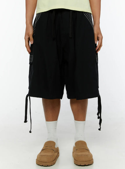 Men's Pocket Cargo Shorts IL515 Black front close-up on model showing elastic drawstring waistband and dual cargo pockets with white stitching
