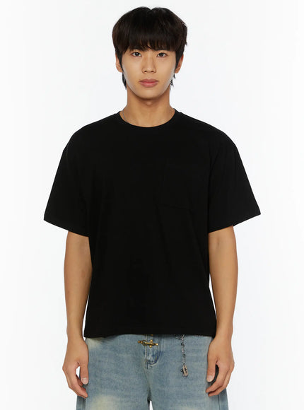 Men's Pocket Semi-Crop T-Shirt IL507 Black close-up front shot on male model showing oversized boxy silhouette crew neck chest pocket and solid black cotton fabric