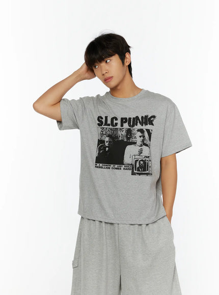 Men's Punk Graphic T-Shirt IL513 Gray front close-up shot on male model hand raised to head showing SLC PUNK black graphic print on heather gray cotton
