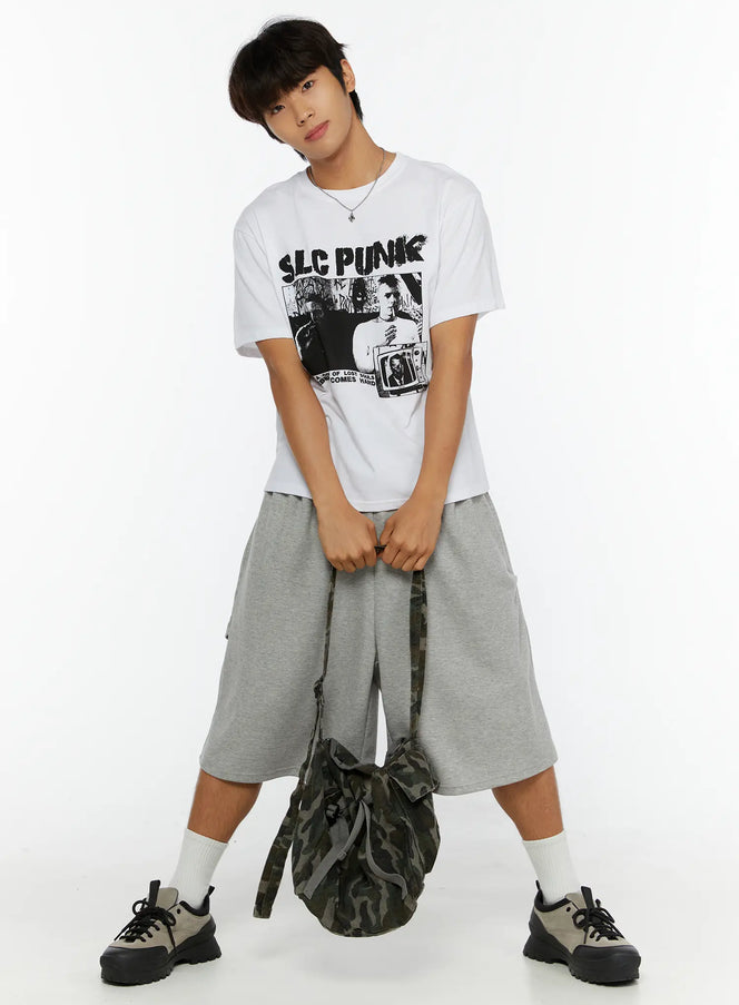 LEWKIN Men's Punk Graphic T-Shirt IL513 White M/L full-body front shot on male model posed with hands clasped holding camo bag styled with gray shorts