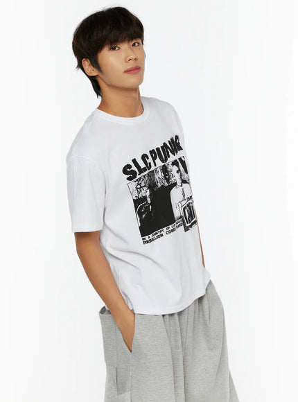 Men's Punk Graphic T-Shirt IL513 White side shot on male model hands in pockets showing SLC PUNK graphic print and relaxed oversized silhouette