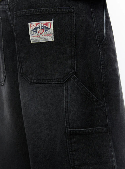 Men's Relaxed Denim Carpenter Shorts IL513 Black close-up detail of back cargo pocket with Finest Quality No Stop brand woven label patch on washed black denim