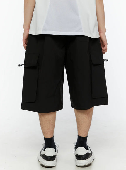 Men's Relaxed Fit Cargo Shorts (Black) IL509 black back shot on model showing rear view of wide-leg fit dual side pockets and layered hem detail