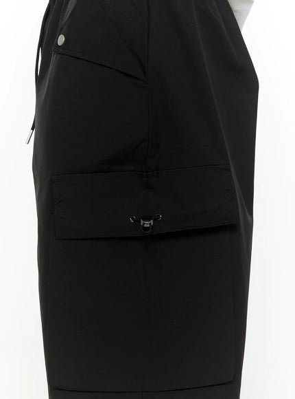 Men's Relaxed Fit Cargo Shorts (Black) IL509 black close-up detail shot of side cargo pocket flap with metal clip hardware and drawstring toggle