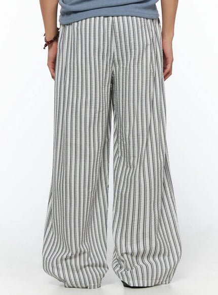 Men's Relaxed-Fit Pajama Pants IL520 Dark blue back shot on model displaying wide-leg cut elastic waistband back panel and vertical stripe seersucker fabric with voluminous hem