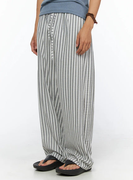 Men's Relaxed-Fit Pajama Pants IL520 Dark blue angled front close-up on model showing button fly detail elastic waistband and textured vertical stripe seersucker fabric with side pocket