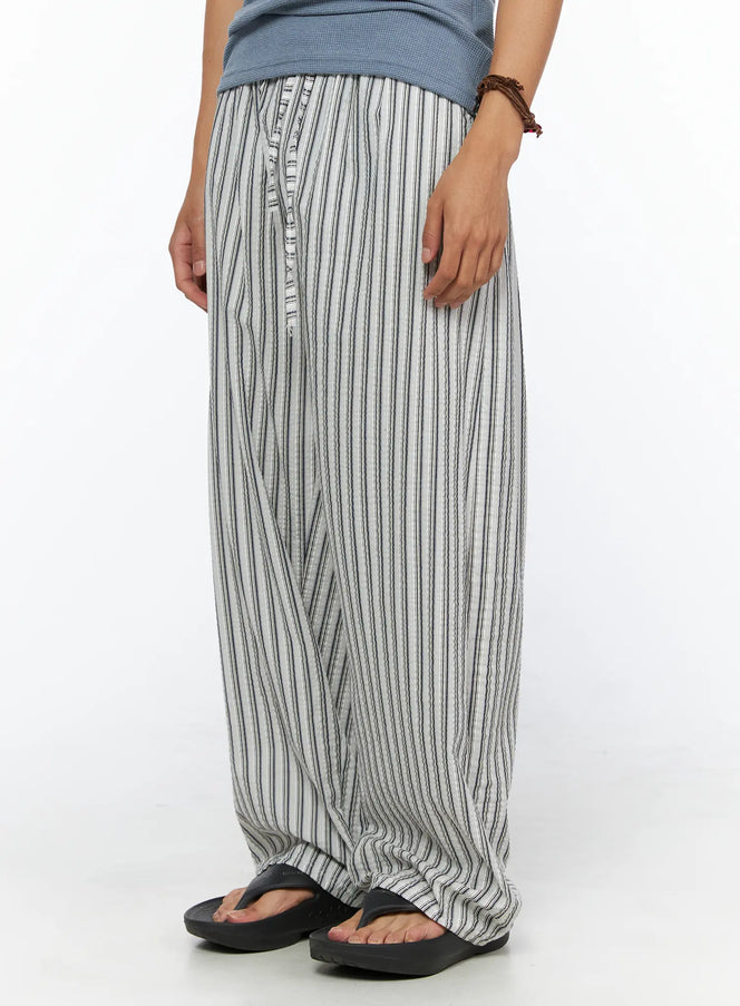 Men's Relaxed-Fit Pajama Pants IL520 Dark blue angled front close-up on model showing button fly detail elastic waistband and textured vertical stripe seersucker fabric with side pocket