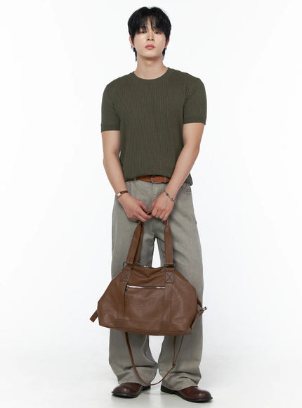 Men's Relaxed Fit Pants (Light Gray) IU523 Light Gray full-body front shot on male model holding large brown leather duffle bag with olive ribbed tee