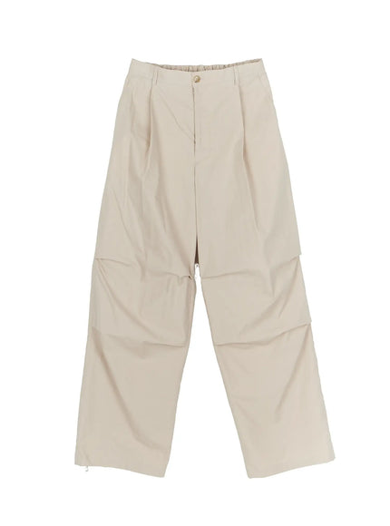 Men's Relaxed-Fit Parachute Pants IL509 Light beige flat-lay front view showing pleated waistband, wide-leg cut, horizontal knee panel seam and zip hem detail