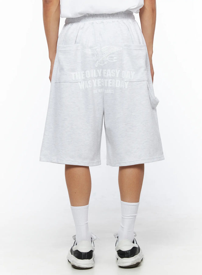 LEWKIN Men's Relaxed-Fit Sweat Shorts IL515 Light gray back view on model wearing white tee and sneakers, US Navy Seals graphic print on heathered cotton fleece