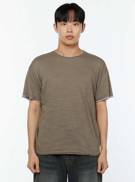 Men's Relaxed Fit T-Shirt IU529 Dark green front close-up half-body shot on male model showing crew neck contrast stitching layered cuff and slub knit texture