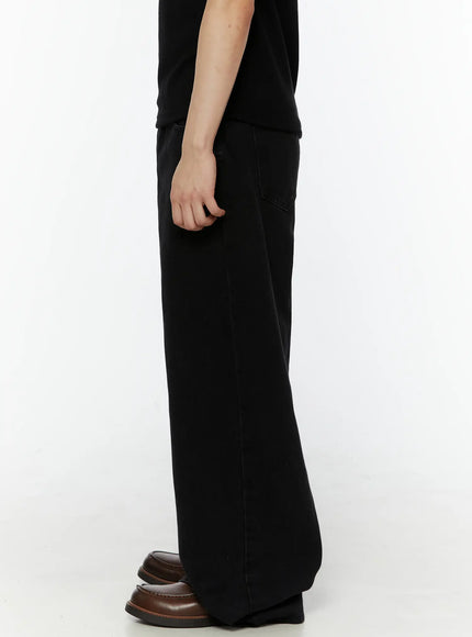 Men's Relaxed Fit Wide Leg Jeans IL509 Black right side view on model showing back pocket placement and wide-leg drape, styled with black tee and brown loafers