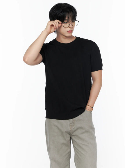 Men's Ribbed Slim Fit Knit T-Shirt IU523 Black half-body front shot on male model adjusting glasses hand raised showing slim ribbed knit fit and short sleeves