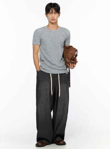 Men's Ribbed Slim-Fit T-Shirt IL520 Gray full-body front shot on male model holding brown leather duffle bag styled with wide-leg black drawstring denim