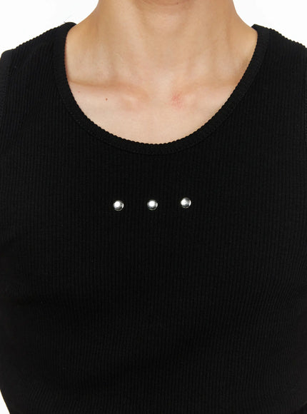 Men's Ribbed Studded Tank Top IL528 Black close-up detail shot showing three silver dome studs on ribbed knit chest fabric near U-neckline