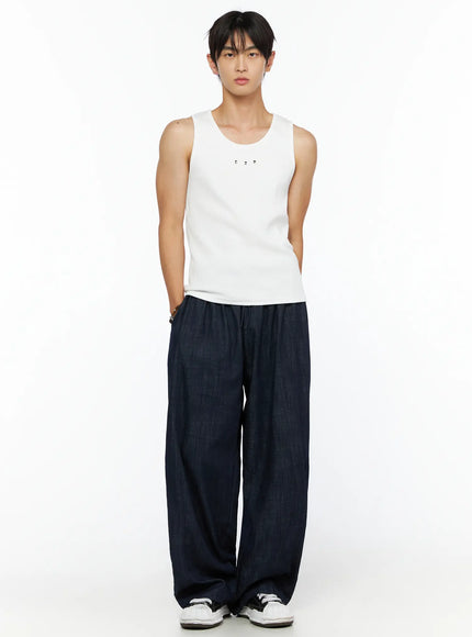 Men's Ribbed Studded Tank Top IL528 White front full-body shot on male model standing hands in pockets styled with navy wide-leg denim trousers and white sneakers