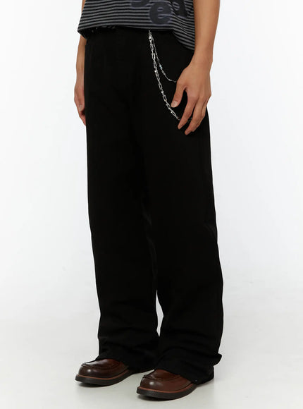 Men's Semi-Flared Black Pants IL509 Black side close-up on model highlighting silver chain detail and wide-leg fabric drape with brown loafers