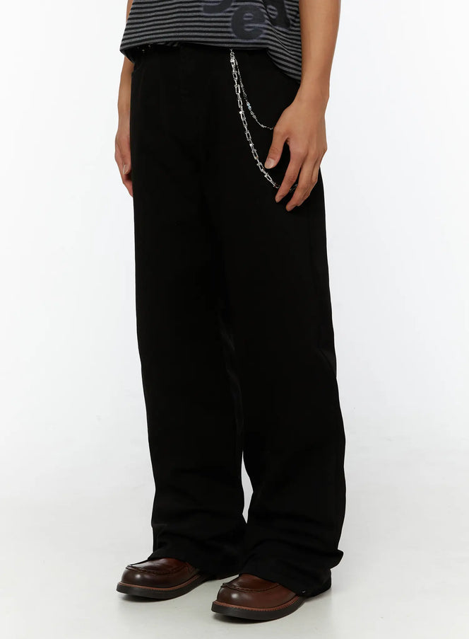 Men's Semi-Flared Black Pants IL509 Black side close-up on model highlighting silver chain detail and wide-leg fabric drape with brown loafers