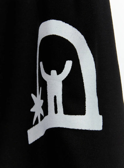 Men's Shooting Star Printed Shorts (Black) IL509 close-up detail of white arch figure graphic print on black cotton fabric, showing human silhouette with raised arms