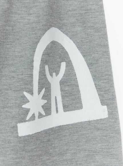 Men's Shooting Star Printed Shorts (Gray) IL509 Gray close-up detail of white arch figure graphic print on heathered gray cotton fabric, showing starburst and person silhouette
