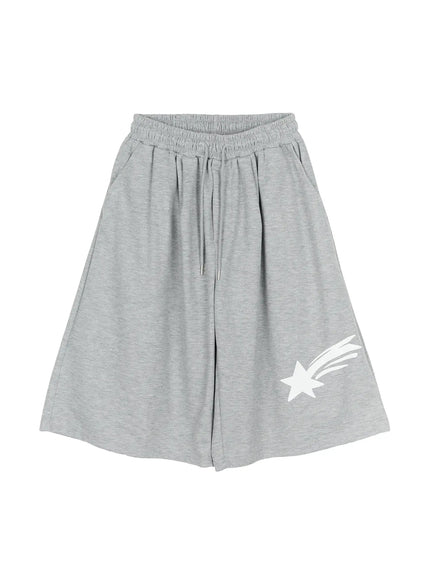 Men's Shooting Star Printed Shorts (Gray) IL509 Gray flat-lay front showing full silhouette, elastic drawstring waistband, wide-leg cut, and white shooting star print on lower right leg
