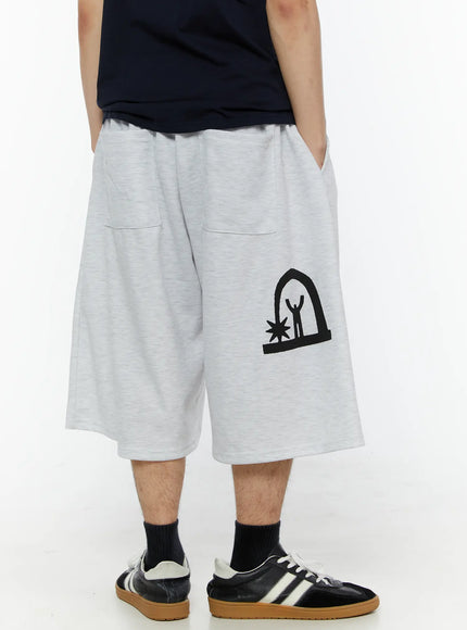 Men's Shooting Star Printed Shorts (Light Gray) IL509 Light gray back view on model showing arch figure graphic print and back patch pockets, wide-leg fit