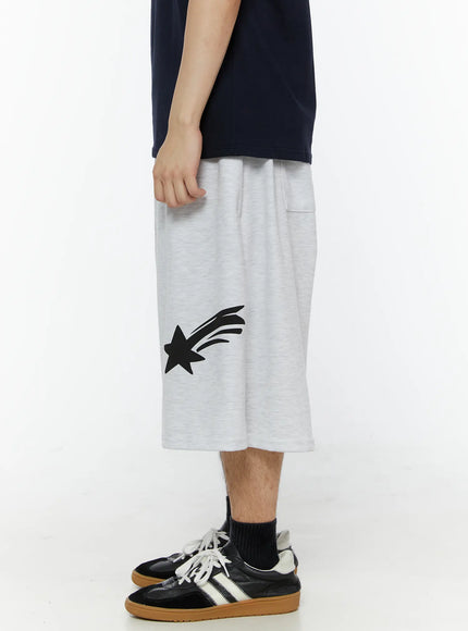 Men's Shooting Star Printed Shorts (Light Gray) IL509 Light gray side view on model showing side pocket and shooting star graphic, relaxed wide-leg silhouette