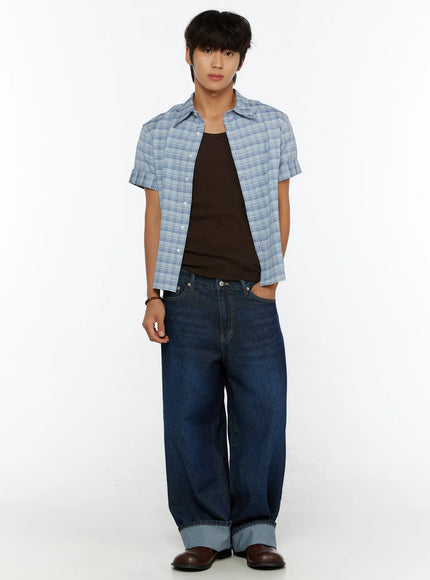 Men's Short Sleeve Plaid Shirt IL515 Blue full front shot on model with one hand in pocket, open over dark tank top and wide-leg cuffed jeans