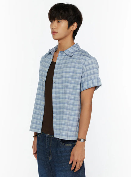 Men's Short Sleeve Plaid Shirt IL515 Blue side close-up shot on model showing collar, button placket, and cropped hem layered over dark tank