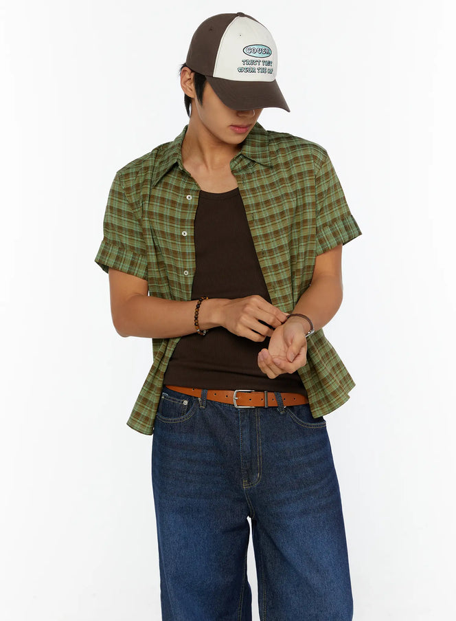 LEWKIN Men's Short Sleeve Plaid Shirt IL515 Green front shot on model wearing cap, open over dark tank top with jeans, relaxed pose looking down