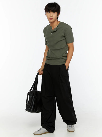 Men's Slim Fit Ribbed T-Shirt IL513 Dark green full-length angled front shot on male model holding black tote bag styled with wide-leg trousers