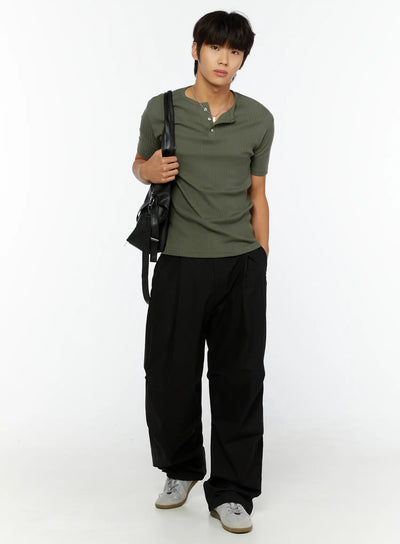 LEWKIN Men's Slim Fit Ribbed T-Shirt IL513 Dark green full-length front shot on male model size M/L styled with black wide-leg pants and crossbody bag