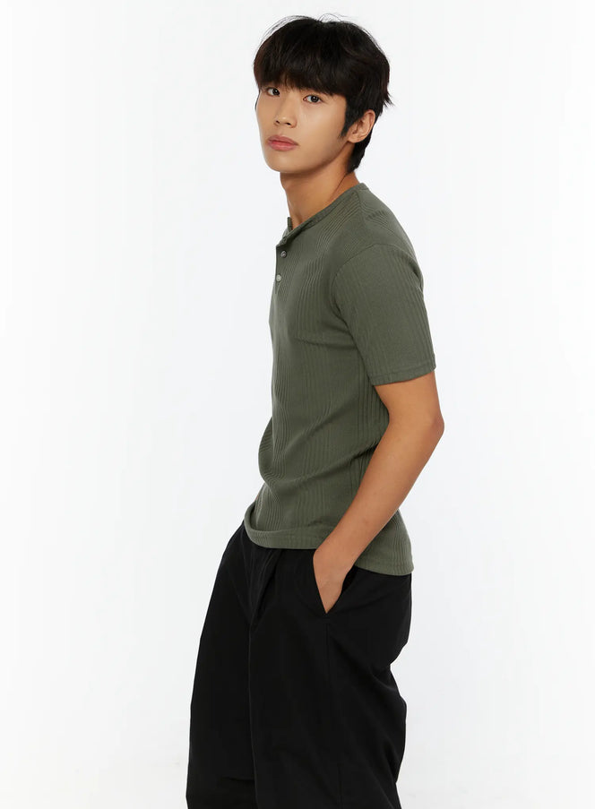 Men's Slim Fit Ribbed T-Shirt IL513 Dark green side shot on male model hands in pockets showing ribbed texture and henley button placket