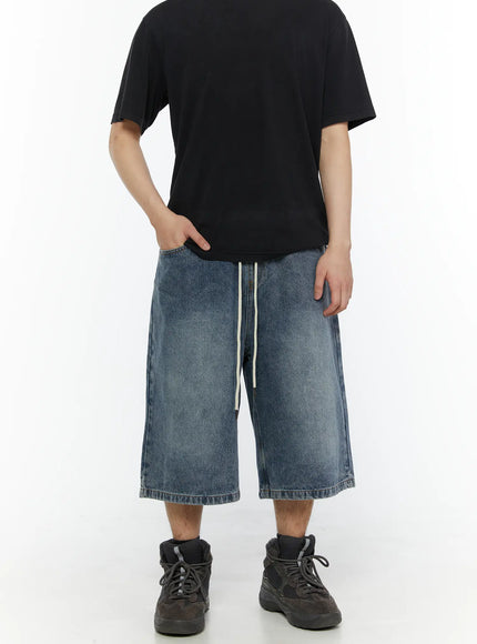 Men's Star Bolt Graphic Print Jorts (Blue) IL507 Blue front view on model paired with black tee showing cream drawstring waist and wide-leg washed denim fit