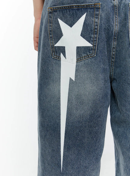 Men's Star Bolt Graphic Print Jorts (Blue) IL507 Blue close-up detail of single back pocket with white star and bolt graphic print on washed blue denim