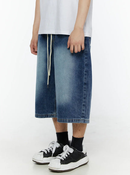 Men's Star Bolt Graphic Print Jorts (Dark Blue) IL507 side view on model showing wide-leg silhouette, washed denim texture and cream drawstring waistband with sneaker styling
