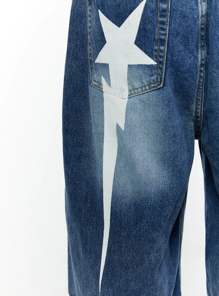 Men's Star Bolt Graphic Print Jorts (Dark Blue) IL507 close-up detail of white star and lightning bolt graphic print on rear hip pocket over washed dark blue denim