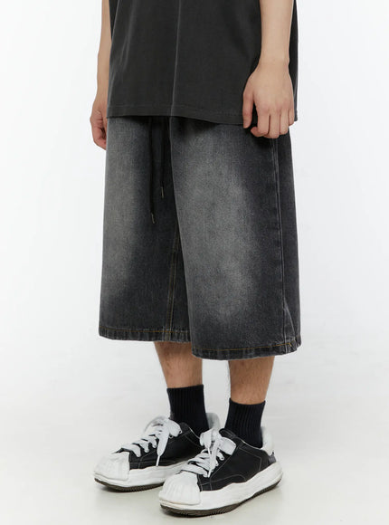 Men's Star Bolt Graphic Print Jorts (Dark Gray) IL507 close-up front view on model showing wide-leg silhouette, faded denim texture and hem stitching